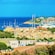 A coastal village with boats moored in the water and multistory Mediterranean architecture